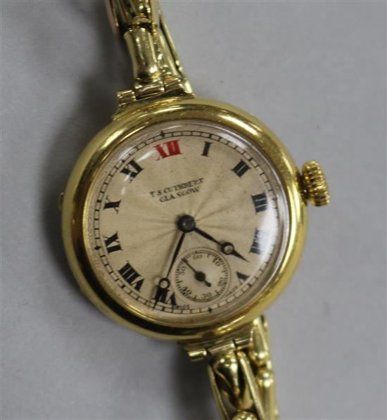 An early 20th century 18ct gold manual wind wrist watch retailed by T.s. Cuthbert, Glasgow, on 15ct gold flexible strap.